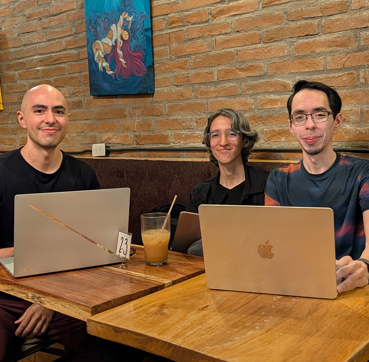 The Yurny team at a café table with their laptops